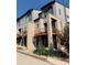 Contemporary townhomes with brick accents and balconies, showcasing modern architecture and design at 10150 Belvedere Loop, Lone Tree, CO 80124