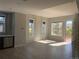 Sun-filled living area featuring large windows, modern finishes, and a seamless transition to the outdoor balcony at 10150 Belvedere Loop, Lone Tree, CO 80124