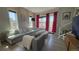 Spacious living room with comfortable seating, bright pink curtains, and abundant natural light at 10150 Belvedere Loop, Lone Tree, CO 80124
