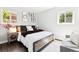 Inviting bedroom with a cozy bed, decorative pillows, and natural light from the windows at 2875 Leyden St, Denver, CO 80207