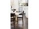 Dining area next to the kitchen features a modern table with stylish chairs and hardwood floors at 2875 Leyden St, Denver, CO 80207