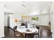 Inviting dining area with a round table, dark wood chairs, and views of the living room and kitchen at 2875 Leyden St, Denver, CO 80207