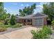 Charming single-story brick home with a two-car garage and well-maintained front yard at 2875 Leyden St, Denver, CO 80207