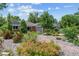 Landscaped front yard with attractive rock ground cover and flowering bushes surrounding a brick home at 2875 Leyden St, Denver, CO 80207