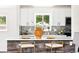 Bright, updated kitchen featuring white cabinets, quartz countertops, and modern appliances at 2875 Leyden St, Denver, CO 80207