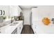 Modern kitchen featuring white cabinets, stainless steel appliances, and elegant countertops at 2875 Leyden St, Denver, CO 80207