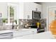 Updated kitchen with white cabinets, stainless steel appliances, and modern fixtures at 2875 Leyden St, Denver, CO 80207