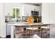 Stylish kitchen island with white quartz countertops, wooden accents, and comfortable seating at 2875 Leyden St, Denver, CO 80207