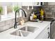 Elegant kitchen with stainless steel sink, white countertops, and stylish backsplash at 2875 Leyden St, Denver, CO 80207