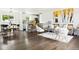 Open-concept living room with hardwood floors, modern decor, and seamless flow to the kitchen at 2875 Leyden St, Denver, CO 80207