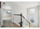 Upstairs hallway with carpet, a railing, and views to other rooms at 9164 Swan River St, Littleton, CO 80125