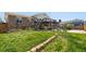 Spacious backyard with a lush lawn, patio area, and a view of the surrounding neighborhood at 11011 Kendall Way, Westminster, CO 80020