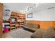 Finished basement with built-in shelving, wood paneling, and comfortable seating at 11011 Kendall Way, Westminster, CO 80020
