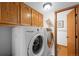 Convenient laundry room with modern washer and dryer, and overhead storage at 11011 Kendall Way, Westminster, CO 80020