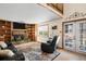 Inviting living room features a brick fireplace, built-in shelving, and access to the outdoor space at 11011 Kendall Way, Westminster, CO 80020
