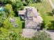 Aerial view of a large property with a spacious backyard, playground, four-car garage, and ample parking space at 11345 W 38Th Ave, Wheat Ridge, CO 80033