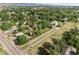 A neighborhood aerial view showcasing a mix of homes, mature trees, and lush green spaces at 11345 W 38Th Ave, Wheat Ridge, CO 80033