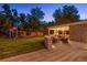Lawn with a play set, stone fire pit with seating, and covered outdoor kitchen at 11345 W 38Th Ave, Wheat Ridge, CO 80033