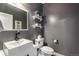 Stylish half-bath with modern fixtures, floating shelves, and a minimalist design at 11345 W 38Th Ave, Wheat Ridge, CO 80033