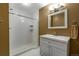 Well-lit bathroom featuring a white tiled shower and stylish vanity with a neutral color scheme at 11345 W 38Th Ave, Wheat Ridge, CO 80033