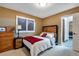 Comfortable bedroom with modern design and wooden accents, featuring a plaid throw at 11345 W 38Th Ave, Wheat Ridge, CO 80033