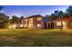 Expansive two-story home with brick facade, mature trees, and lush green lawn at 11345 W 38Th Ave, Wheat Ridge, CO 80033