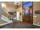 Grand foyer showcasing a soaring ceiling, elegant staircase, and statement front door at 11345 W 38Th Ave, Wheat Ridge, CO 80033