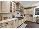 Well-lit kitchen with stainless steel appliances, white cabinets, and a decorative blue rug at 11345 W 38Th Ave, Wheat Ridge, CO 80033