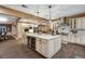Gourmet kitchen featuring a center island, wine fridge, and stainless steel appliances at 11345 W 38Th Ave, Wheat Ridge, CO 80033
