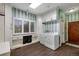 Bright laundry room with modern washer and dryer, and storage with striped walls at 11345 W 38Th Ave, Wheat Ridge, CO 80033