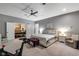 Serene main bedroom with neutral colors, a ceiling fan, and access to an adjacent dining area at 11345 W 38Th Ave, Wheat Ridge, CO 80033