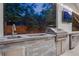 Outdoor kitchen features a stainless steel grill, sink, refrigerator, and a large countertop, perfect for entertaining guests at 11345 W 38Th Ave, Wheat Ridge, CO 80033