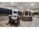 Spacious covered outdoor living area with an outdoor kitchen, tv and comfortable seating at 11345 W 38Th Ave, Wheat Ridge, CO 80033