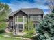 Backyard view with a patio and large windows at 12451 Turquoise Terrace Pl, Castle Pines, CO 80108