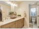 Bright bathroom with a double sink vanity, granite counters, and a separate shower room at 12451 Turquoise Terrace Pl, Castle Pines, CO 80108