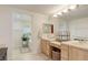 Bright bathroom with dual vanities, decorative mirrors, and tub in the background at 12451 Turquoise Terrace Pl, Castle Pines, CO 80108