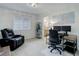 A well-lit bedroom featuring comfortable chair, a desk, and calming decor at 12451 Turquoise Terrace Pl, Castle Pines, CO 80108