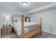 Cozy bedroom featuring wood frame bed, bedside table and soothing decor at 12451 Turquoise Terrace Pl, Castle Pines, CO 80108