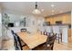 Bright dining area with hardwood floors open to the kitchen bar featuring upholstered bar stools, perfect for everyday living at 12451 Turquoise Terrace Pl, Castle Pines, CO 80108