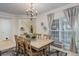 Bright dining room featuring a wooden table set, stylish accents, and ample natural light at 12451 Turquoise Terrace Pl, Castle Pines, CO 80108