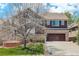 Charming two-story home featuring a two car garage, mature landscaping, and beautiful architecture at 12451 Turquoise Terrace Pl, Castle Pines, CO 80108
