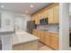 Modern kitchen featuring stainless steel appliances, wooden cabinets, and hardwood flooring at 12451 Turquoise Terrace Pl, Castle Pines, CO 80108