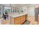 Bright kitchen featuring wooden cabinets, stainless steel dishwasher, and hardwood flooring at 12451 Turquoise Terrace Pl, Castle Pines, CO 80108