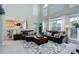 Inviting living room with soaring ceilings, plush sofas, and abundant natural light at 12451 Turquoise Terrace Pl, Castle Pines, CO 80108