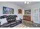 Living room with dart board, painting, stone floors and an adjacent wet bar at 12451 Turquoise Terrace Pl, Castle Pines, CO 80108