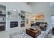 Comfortable living room with fireplace, shelves, and seamless access to the kitchen at 12451 Turquoise Terrace Pl, Castle Pines, CO 80108