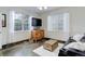 Comfortable living room with stone floors, large windows, and neutral tones at 12451 Turquoise Terrace Pl, Castle Pines, CO 80108