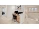 Neutral toned loft area with a computer desk, chair, and natural light streaming through the windows at 12451 Turquoise Terrace Pl, Castle Pines, CO 80108