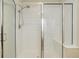 Bathroom shower featuring glass doors, tiled walls, and a built-in shower bench at 12451 Turquoise Terrace Pl, Castle Pines, CO 80108