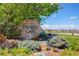 Swim Club at Daniel's Gate sign surrounded by decorative shrubs, boulders, and lush greenery at 12451 Turquoise Terrace Pl, Castle Pines, CO 80108